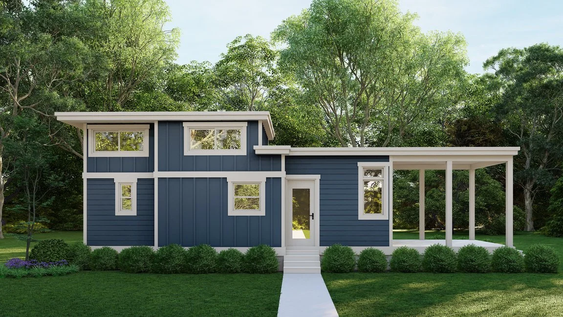 Front view of a modern blue two-story house with white trim and a porch, surrounded by green trees and bushes.