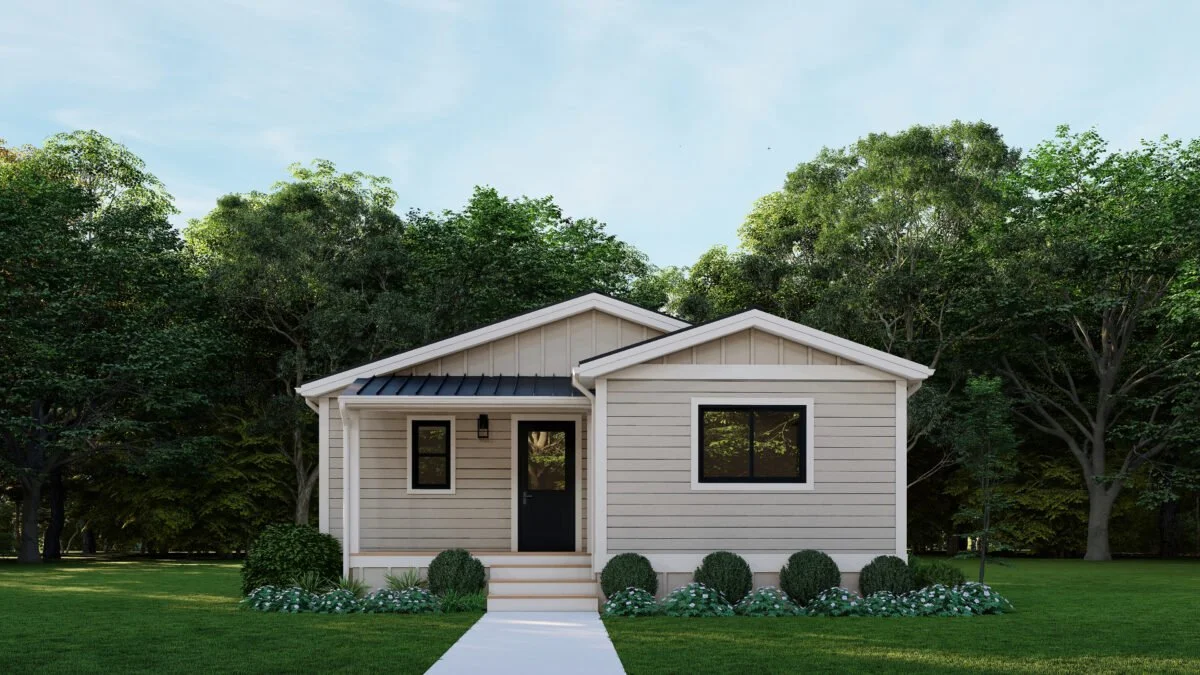 Front view of a small modern house with white siding, black door, and windows, surrounded by green lawn and trees.