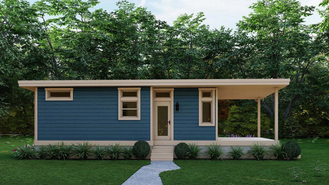 Small modern house with blue siding, white trim, multiple windows, a door, small steps leading to the entrance, a porch on the right side, and surrounded by green grass and bushes with trees in the background.