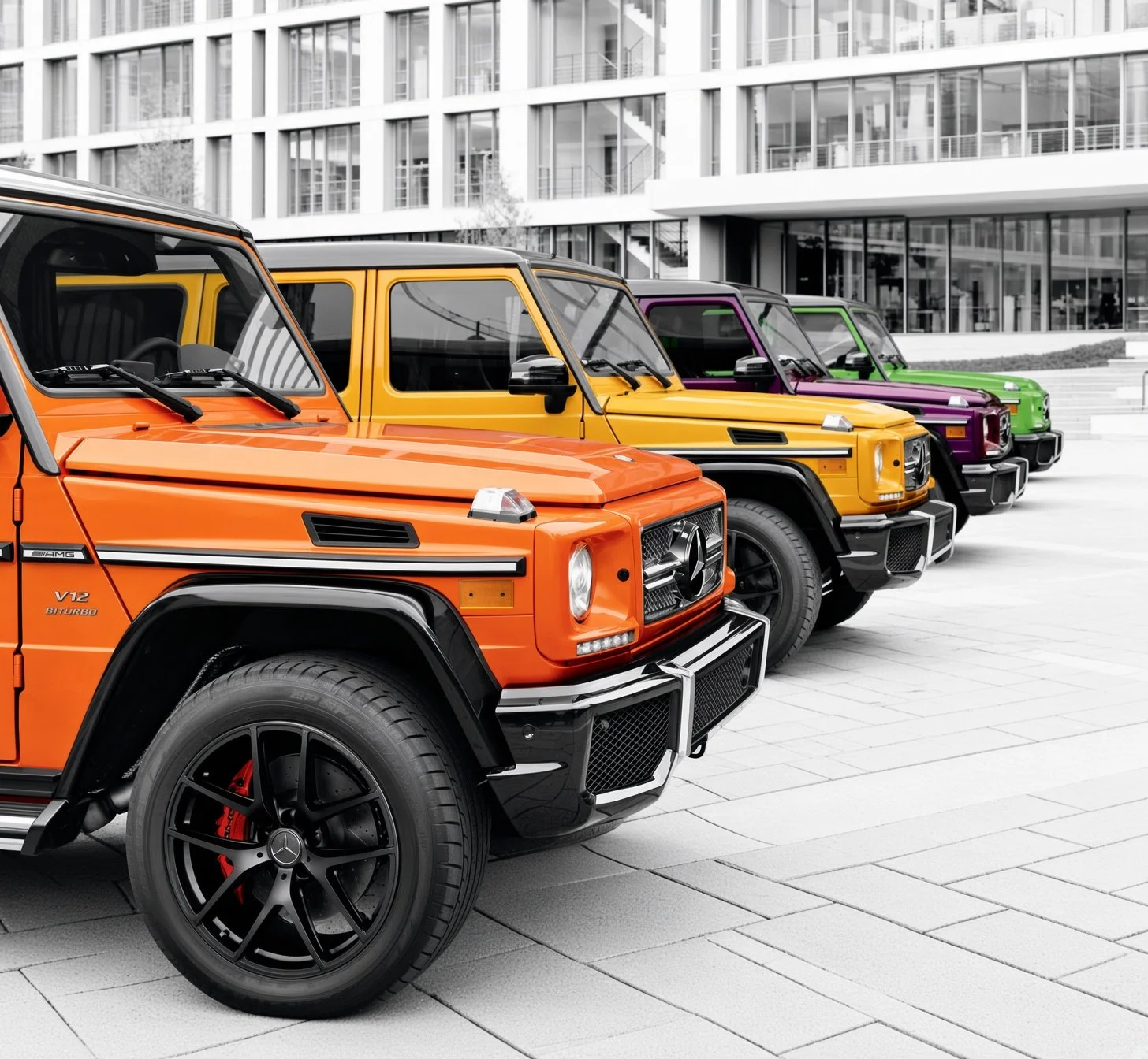 Colorful lineup of luxury Mercedes-Benz G-Class SUVs in orange, yellow, purple, and green parked in front of a modern building with glass windows.