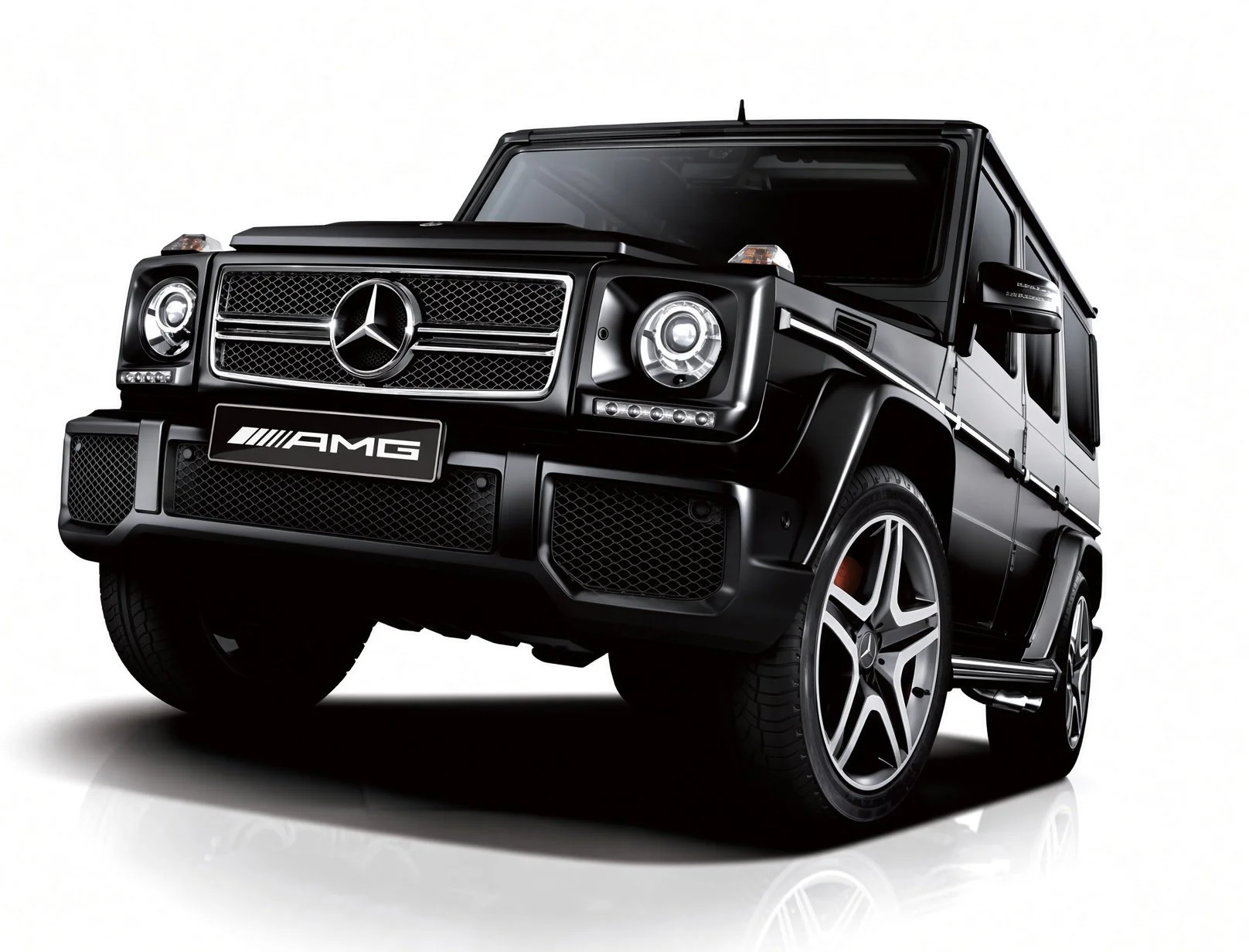 A black Mercedes-Benz G-Class SUV with AMG branding, featuring large alloy wheels and distinctive front grille and headlights, on a white background.