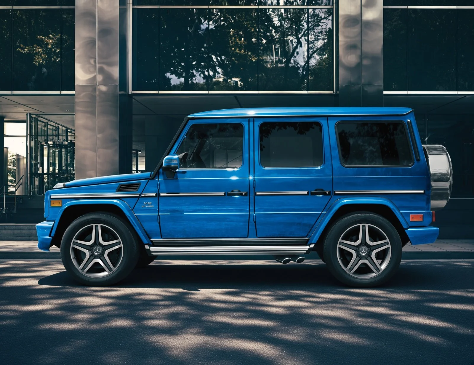 A bright blue Mercedes-Benz G-Class SUV parked outside a modern glass building.