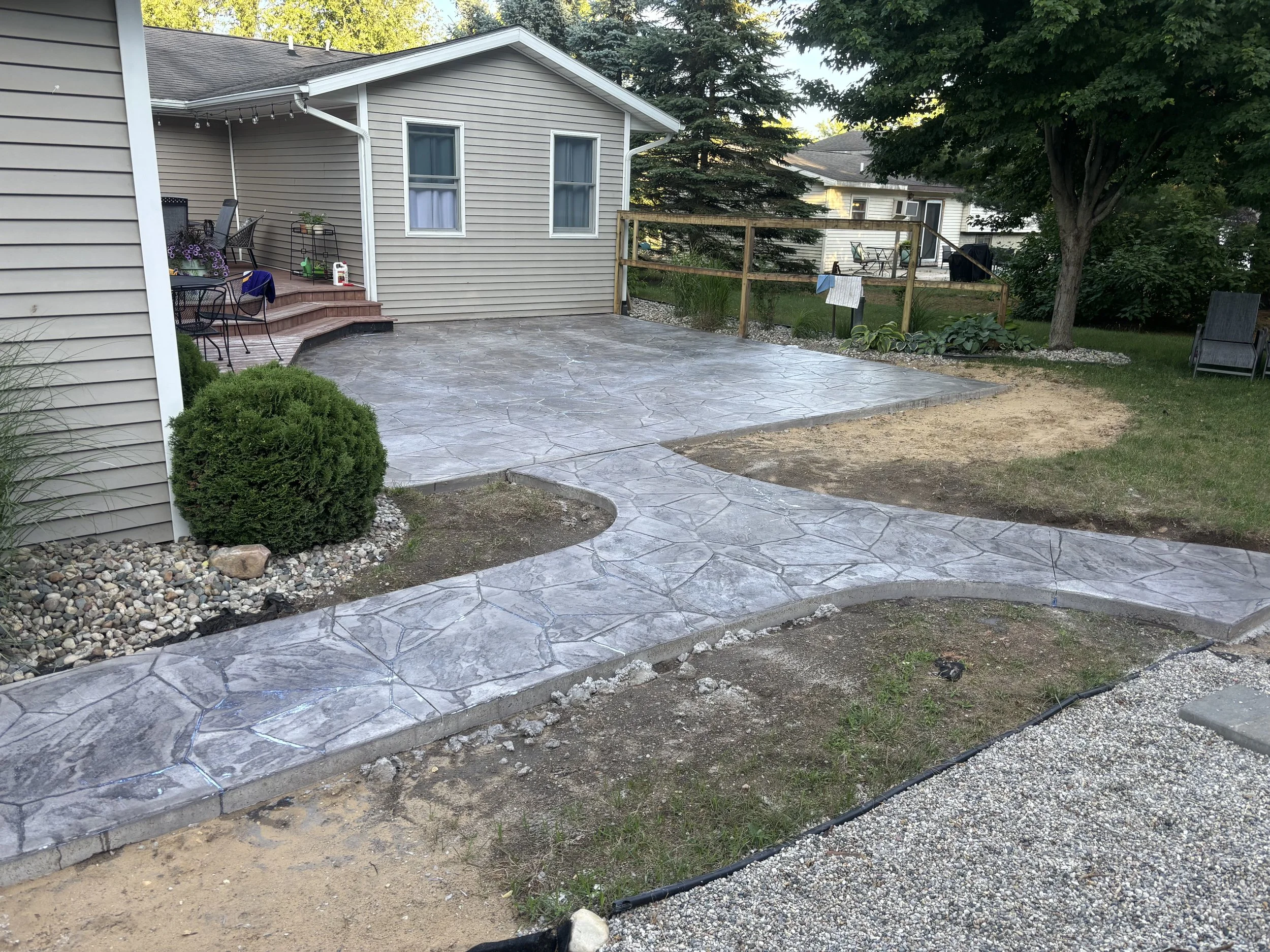 A backyard with a stamped and finished concrete patio, where many memories are to be made.
