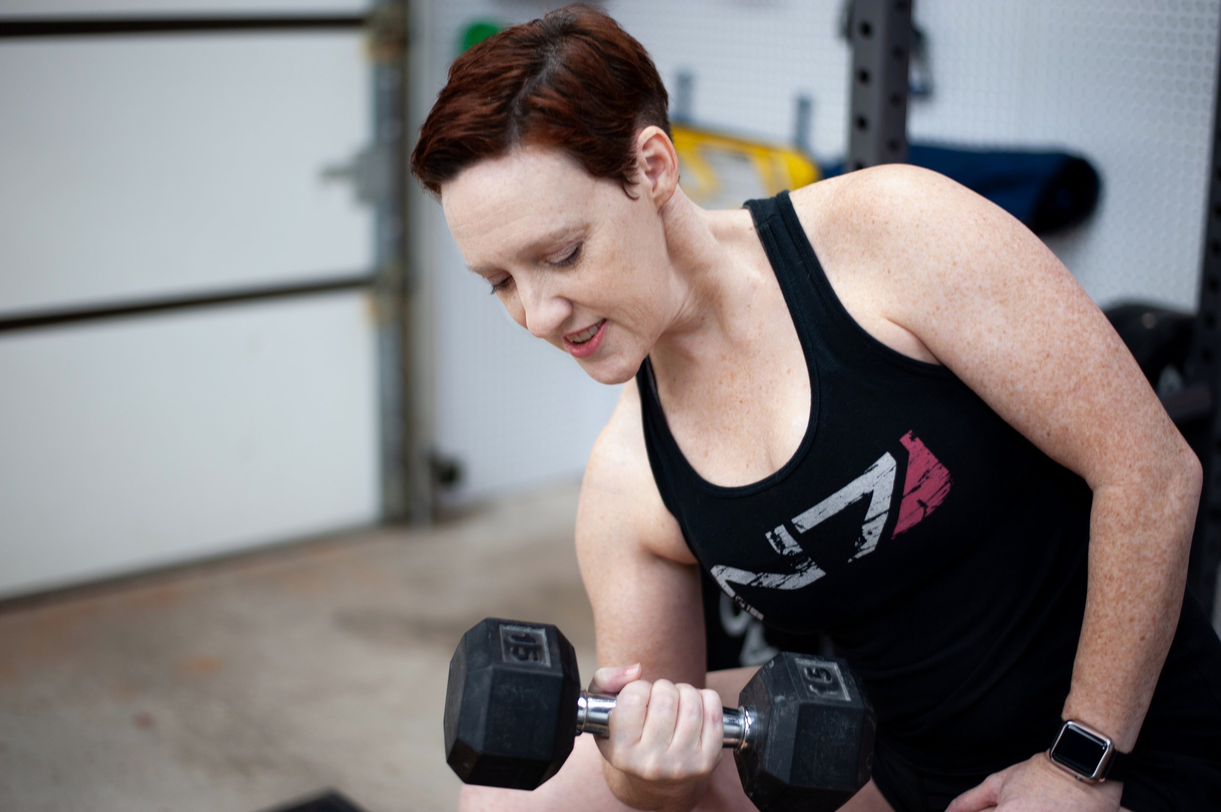 Kristyn McGeehan performing a concentration curl with a dumbbell