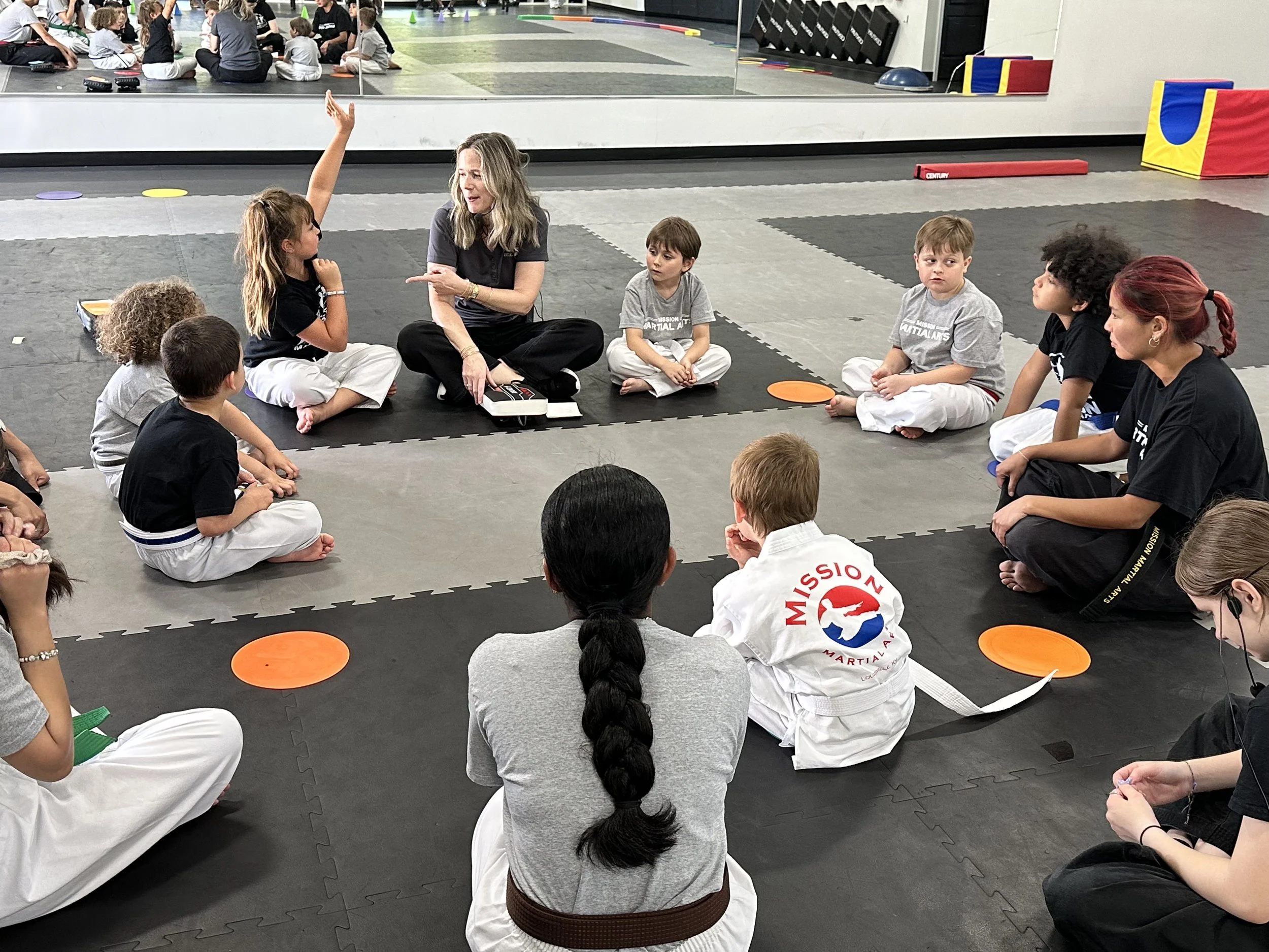 Tiny Tigers actively listening to the instructor during circle time