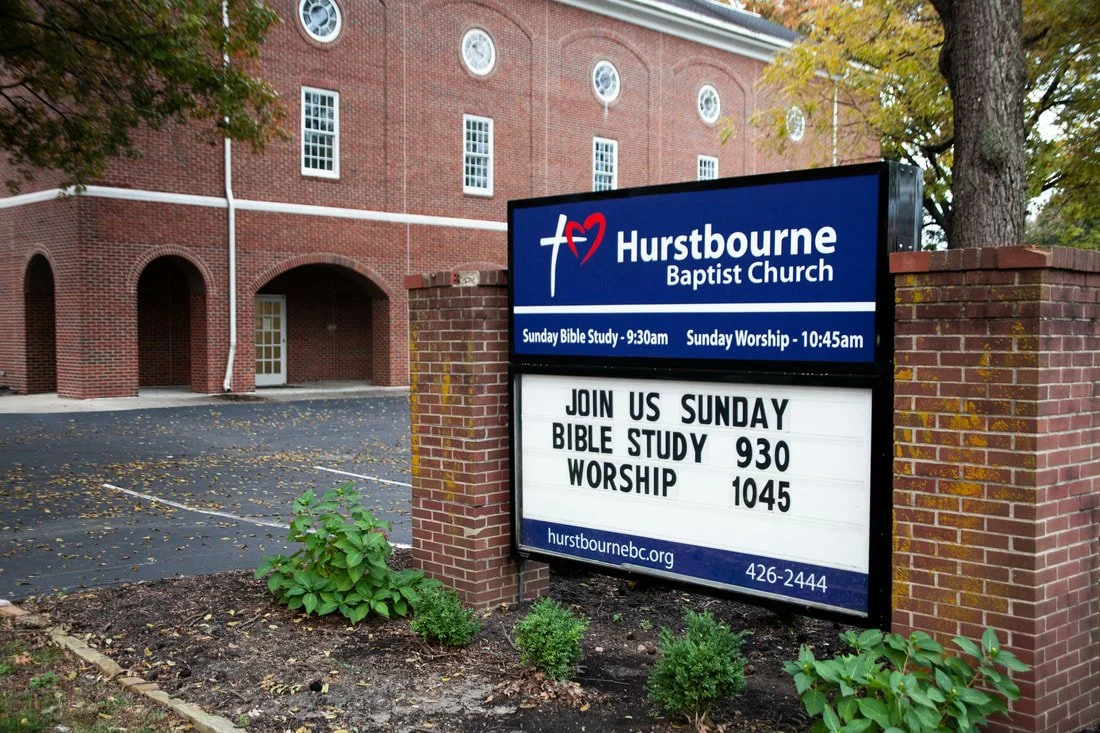 Signboard outside Hurstbourne Baptist Church announcing Sunday Bible Study at 9:30 am and Sunday Worship at 10:45 am, with contact information and website URL.