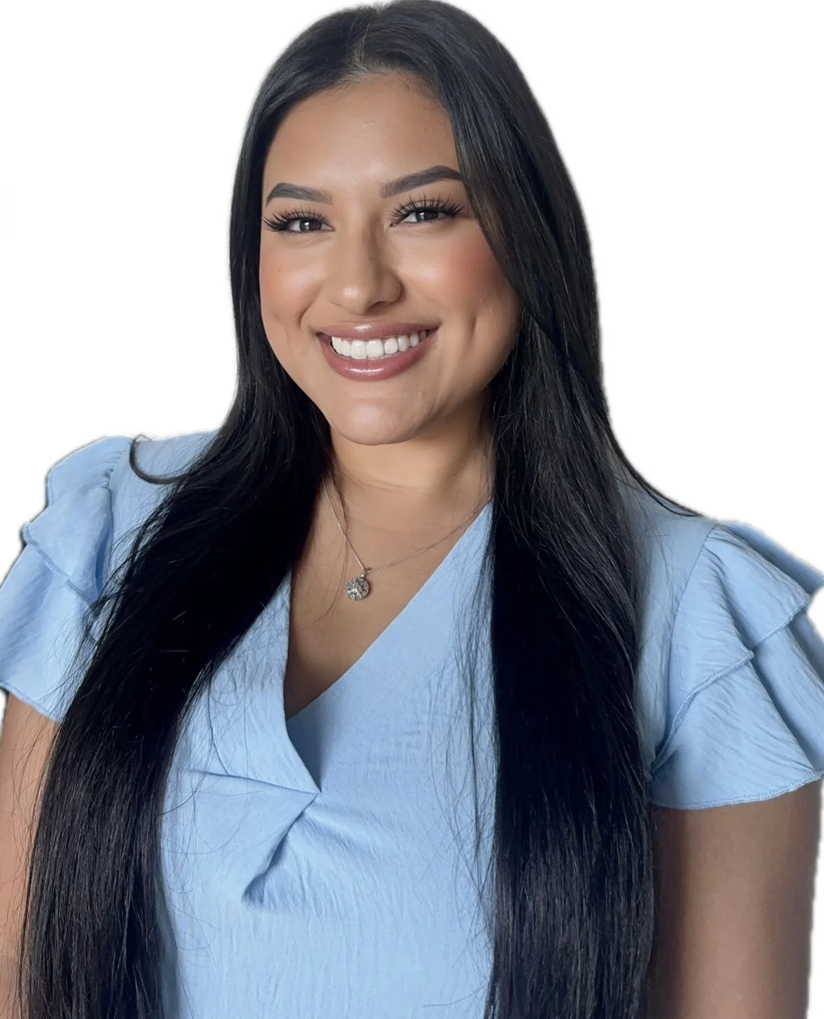 A woman with long black hair, smiling, wearing a light blue top and a silver necklace, against a white background.