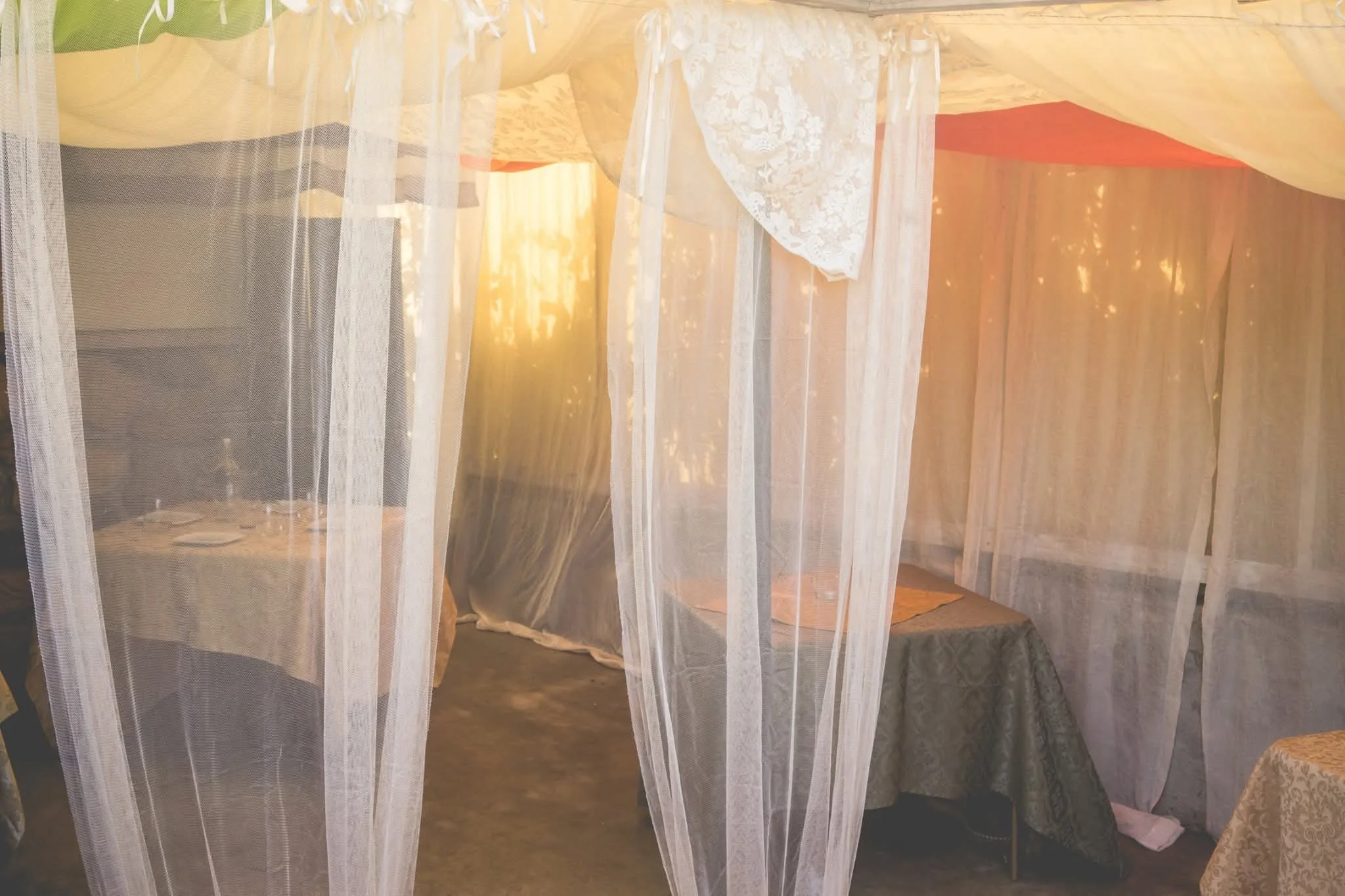 Sheer curtain-draped dining tables at Moroccan Night pop-up event
