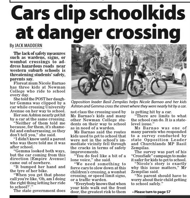 Black and white photo of three children with bicycles crossing a street at a crosswalk, accompanied by two adults as they help children cross safely.