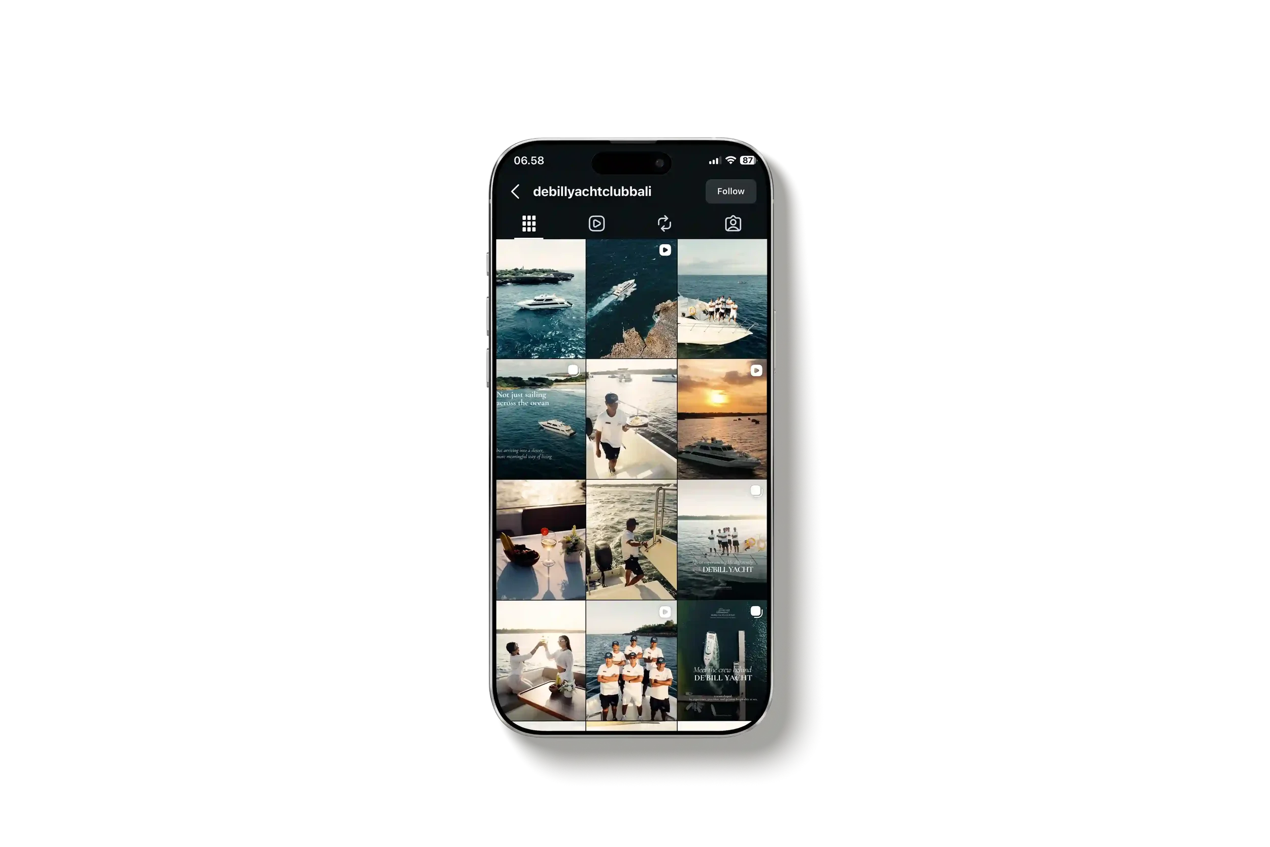 A smartphone screen displaying an Instagram profile of 'debillyachtclubbali' with a grid of photos featuring boats, the ocean, and people on a yacht at sunset.