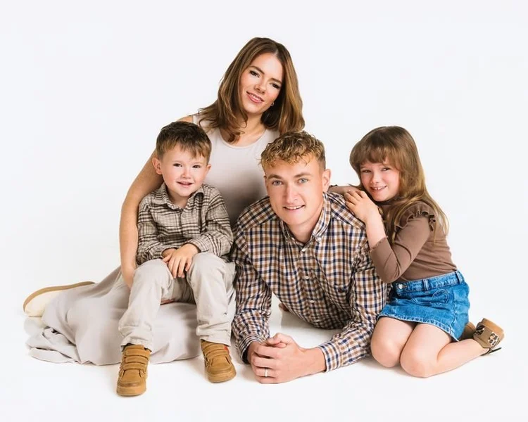 Family of four in browns and soft checks