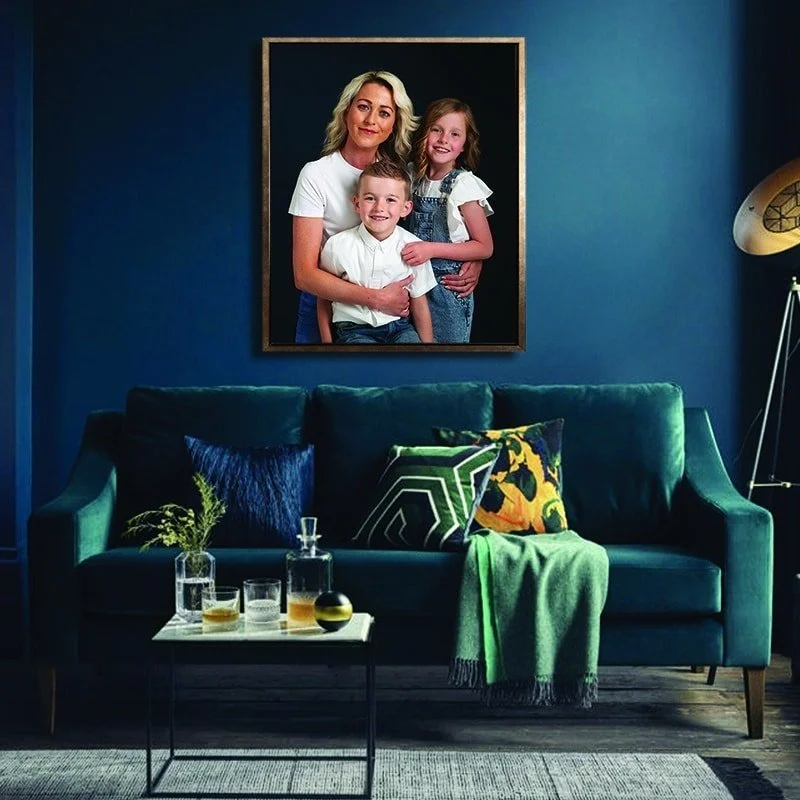 Tray framed family portrait above a green sofa