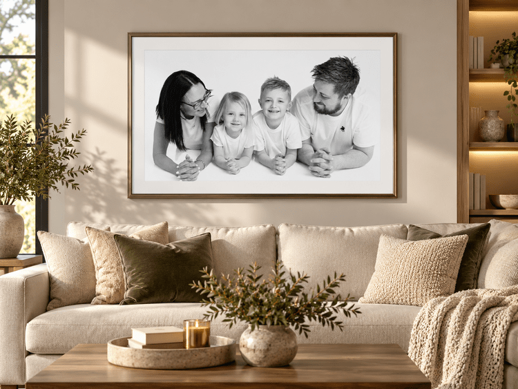 Large family portrait hanging above a sofa in a cosy living room