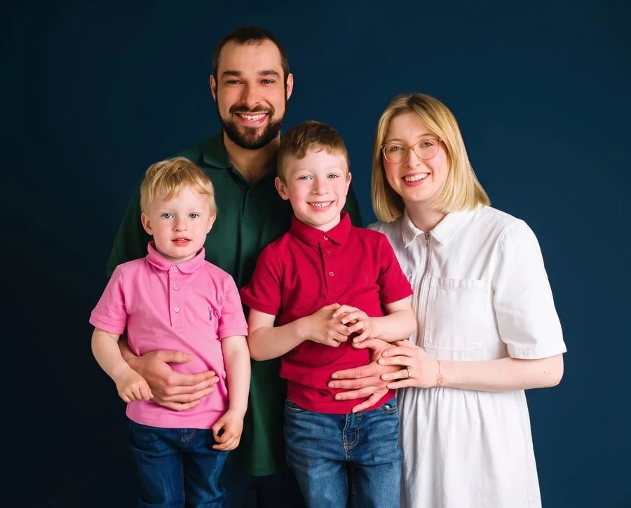 Family in clashing colours, one in white and one in dark green