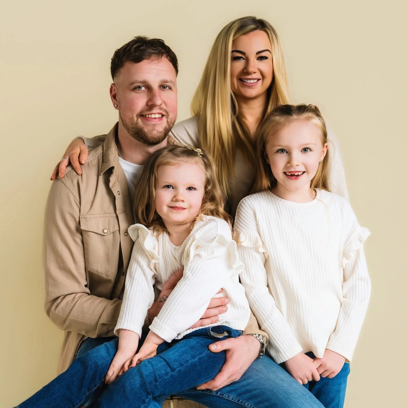 Family of four in cream, beige and denim