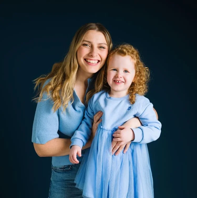 Mum and her wee girl in matching blues on navy