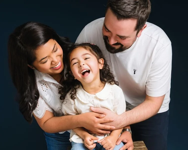 Family in white against a navy background