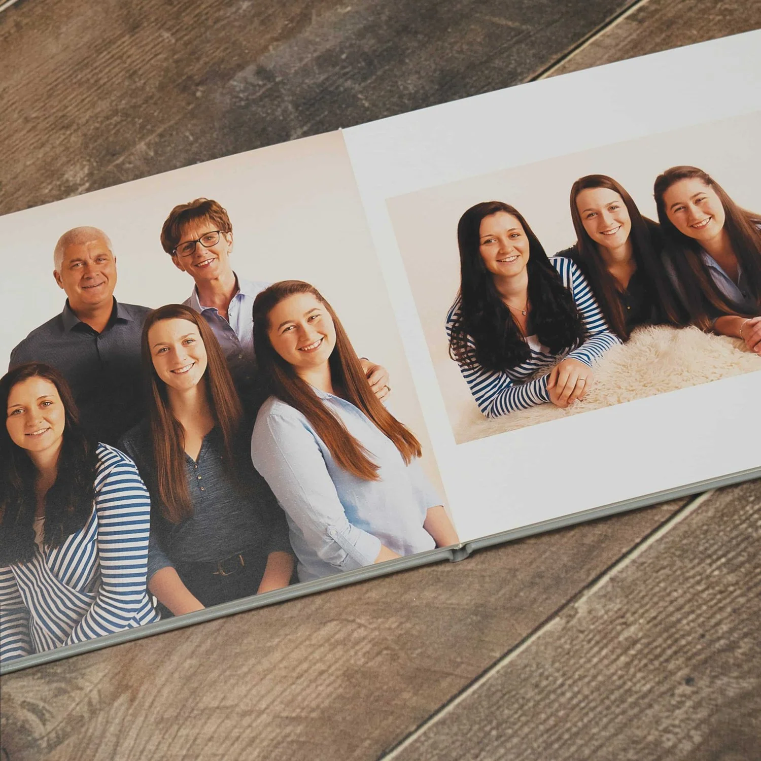 Open keepsake album showing family portraits