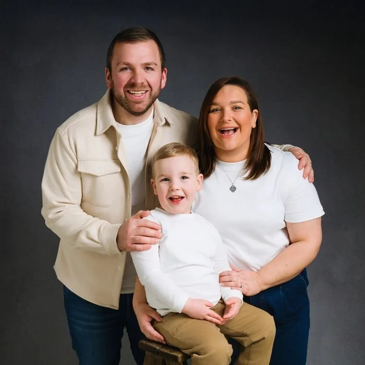 Family in cream and white against grey