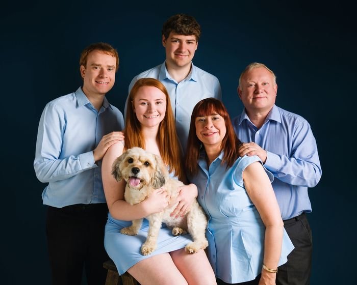 Family in blue with the family dog