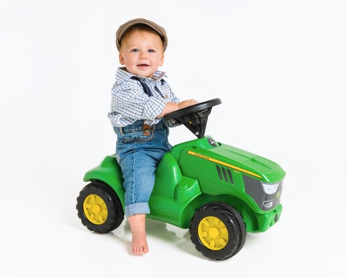 Wee boy on his toy tractor