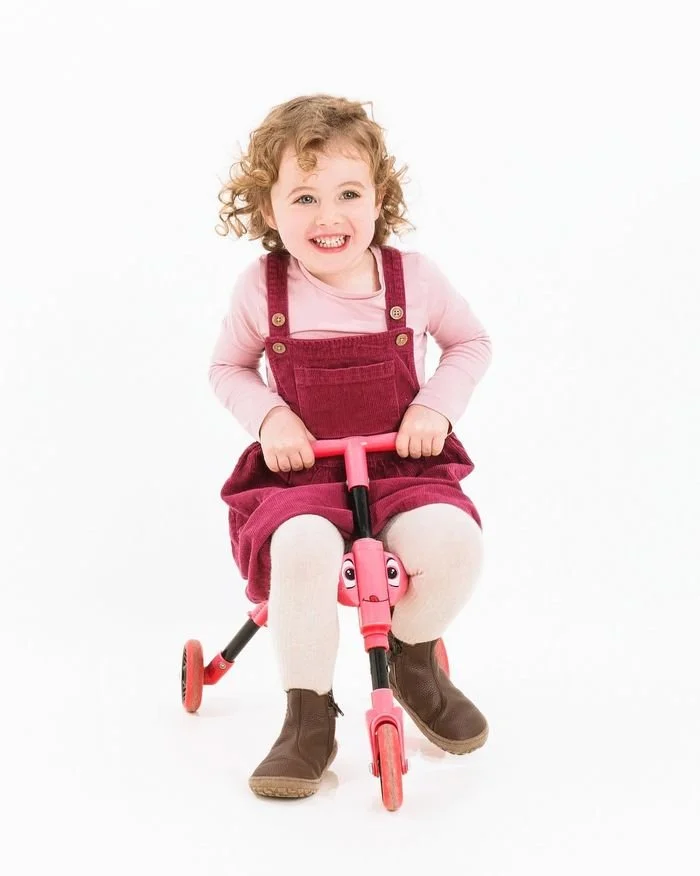 Wee girl on her pink trike