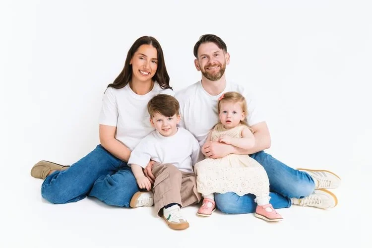 Family of four in white t-shirts and jeans