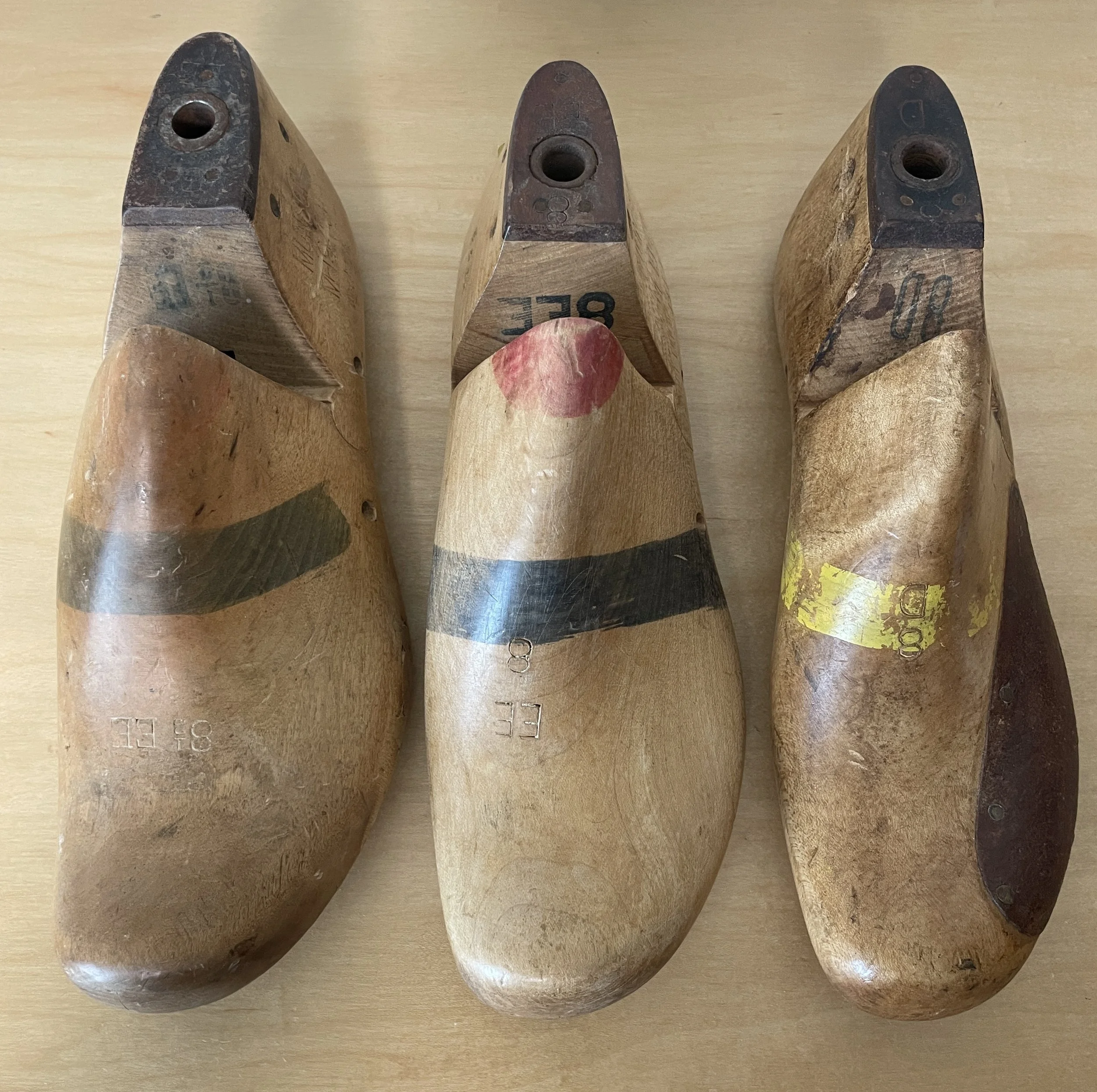 Top view of three Munson wooden shoe lasts in different sizes, used as measurement references for the development of Rustroops Product No. 1.