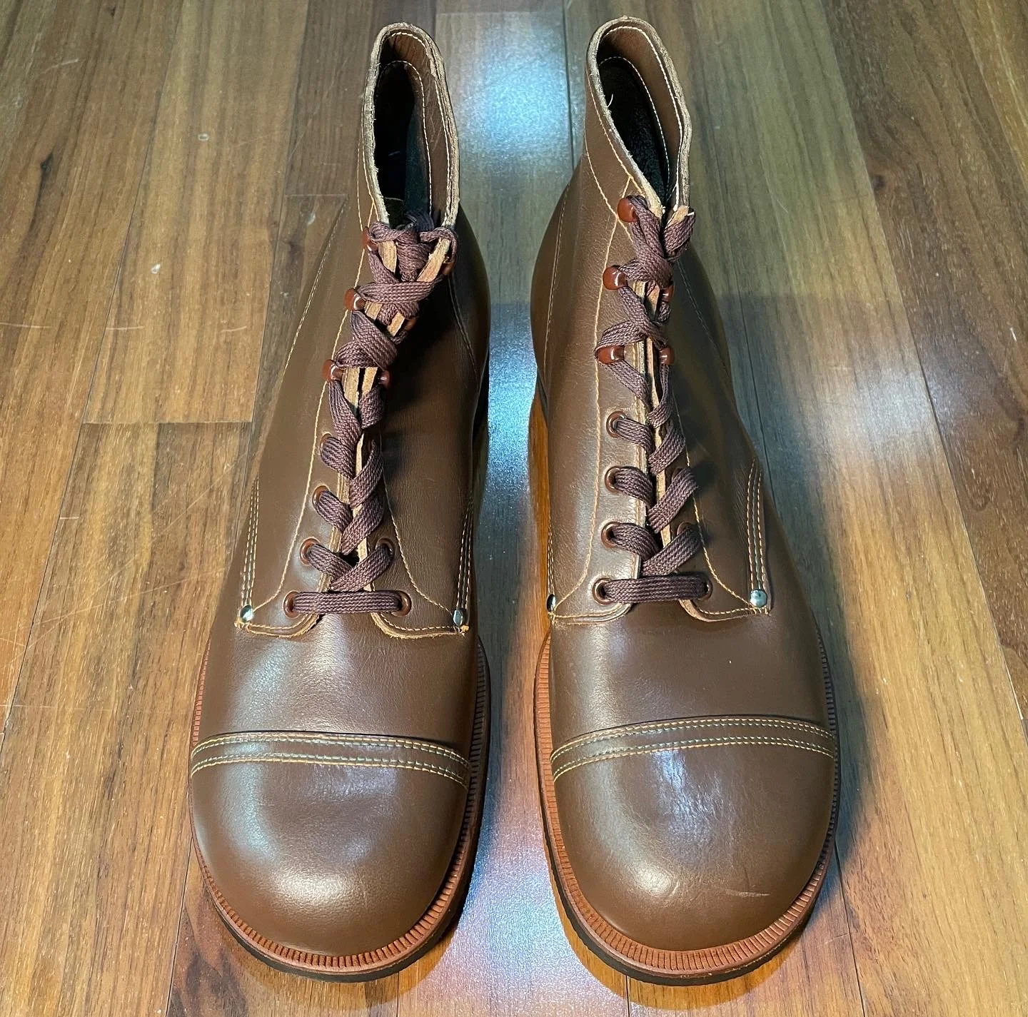International Shoe Company Star Brand work boots, c. 1930s. A reference pair showing the cap-toe shape, riveted quarters, eyelet layout, and restrained work-boot proportions.