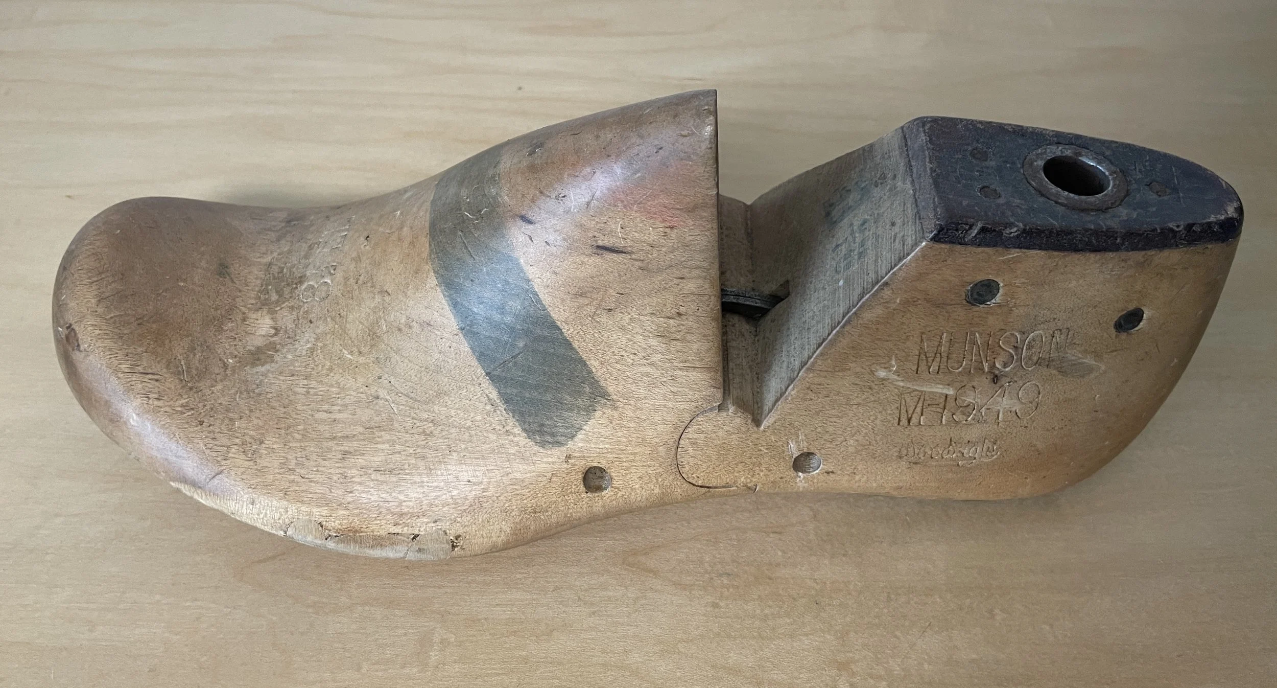 Vintage wooden shoe last stamped “MUNSON M-1949,” side view.