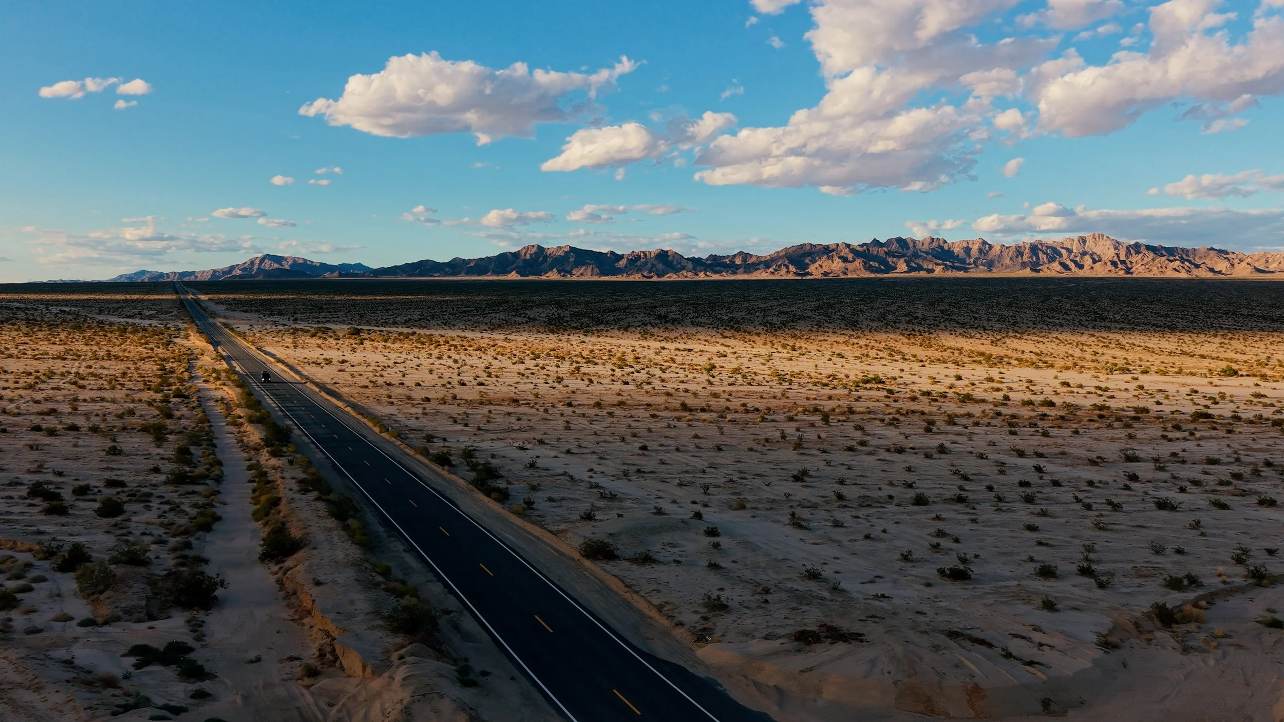 Aerial drone view of a roadway and desert landscape captured by Packman Drones.