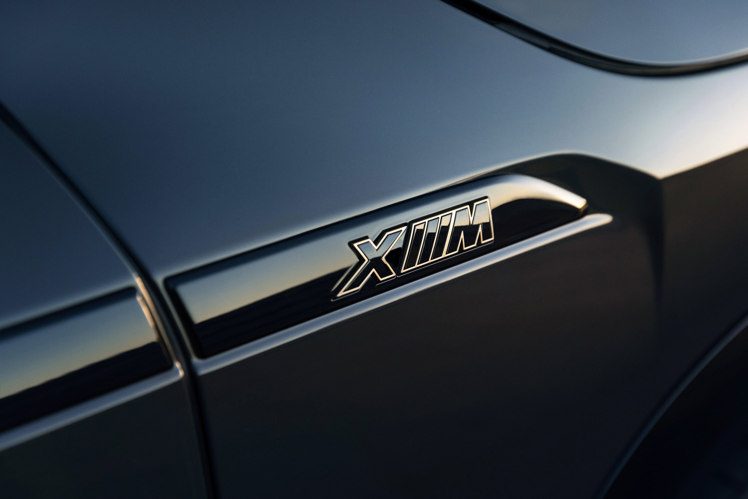BMW XM automotive detail photography highlighting the performance model badging and exterior design