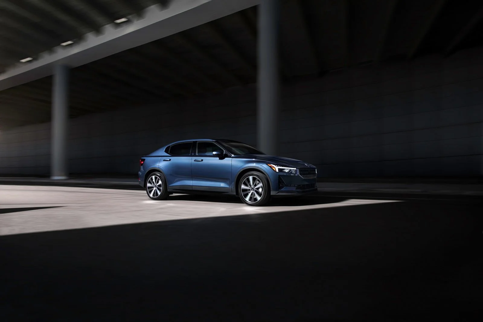 Commercial automotive lifestyle advertising campaign photography of a Polestar 2 luxury EV in an urban city environment.