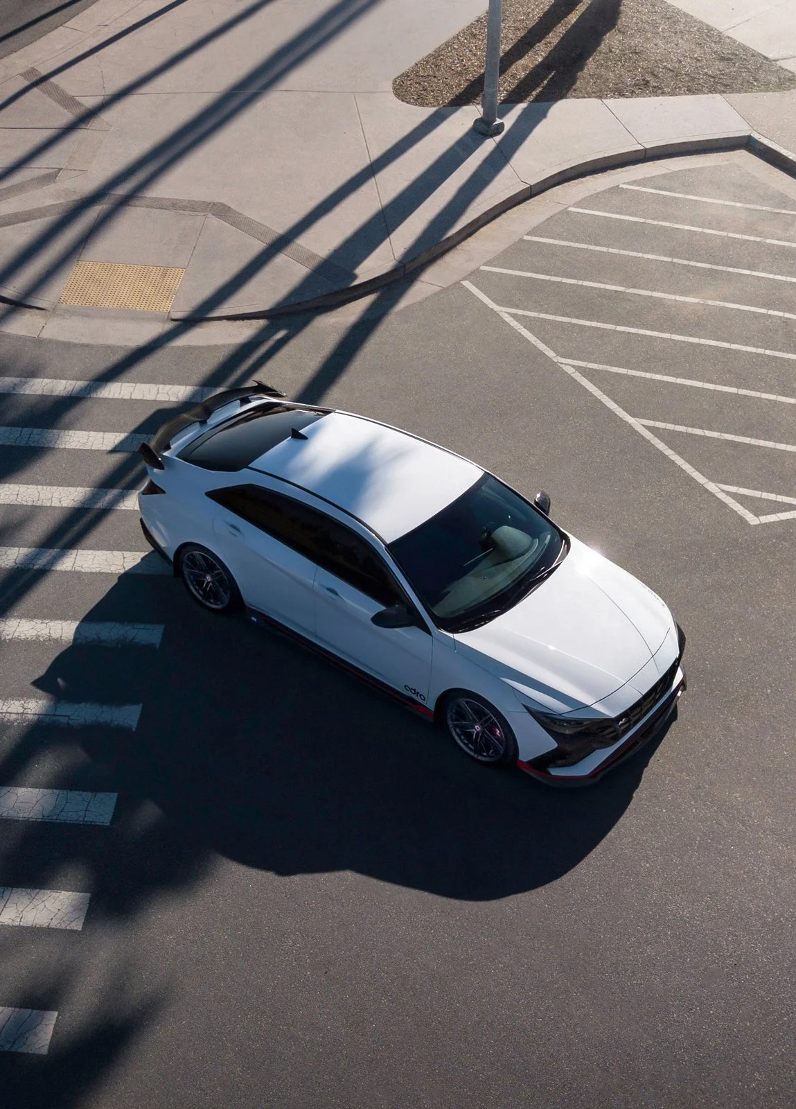 Exquisite automotive photography featuring a top down view of a Hyundai Elantra N car which highlights the car's sleek and performance oriented design.