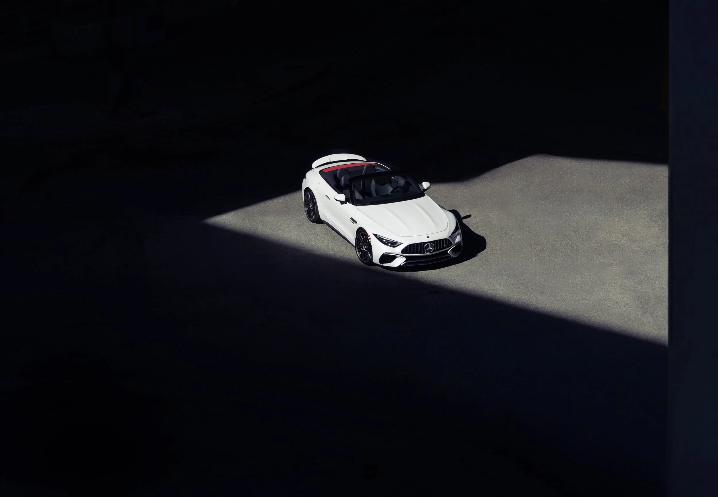 Mercedes-AMG SL photographed in dramatic architectural light for an automotive advertising campaign
