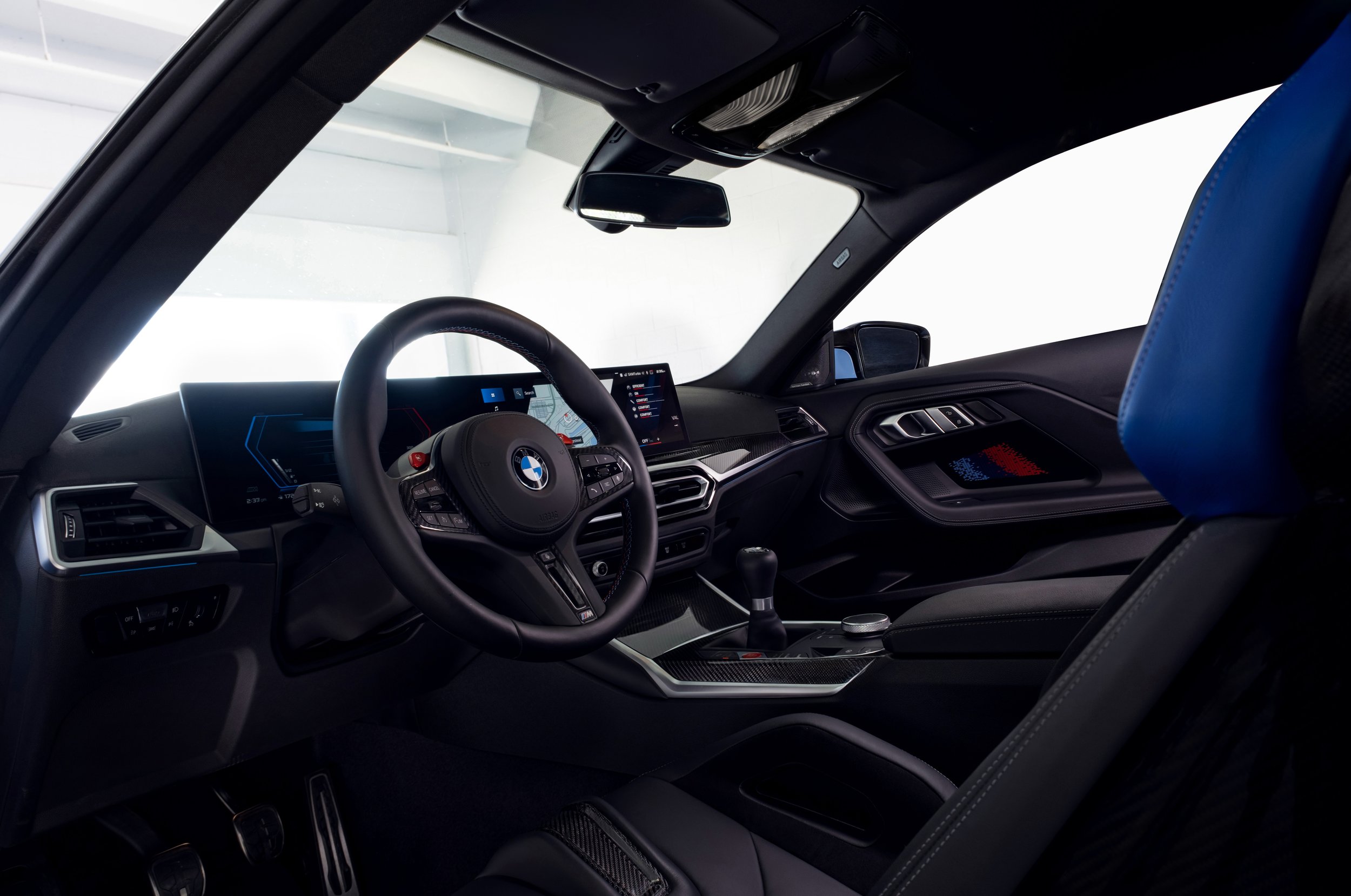 BMW M2 interior photography showcasing the performance cockpit and manual transmission