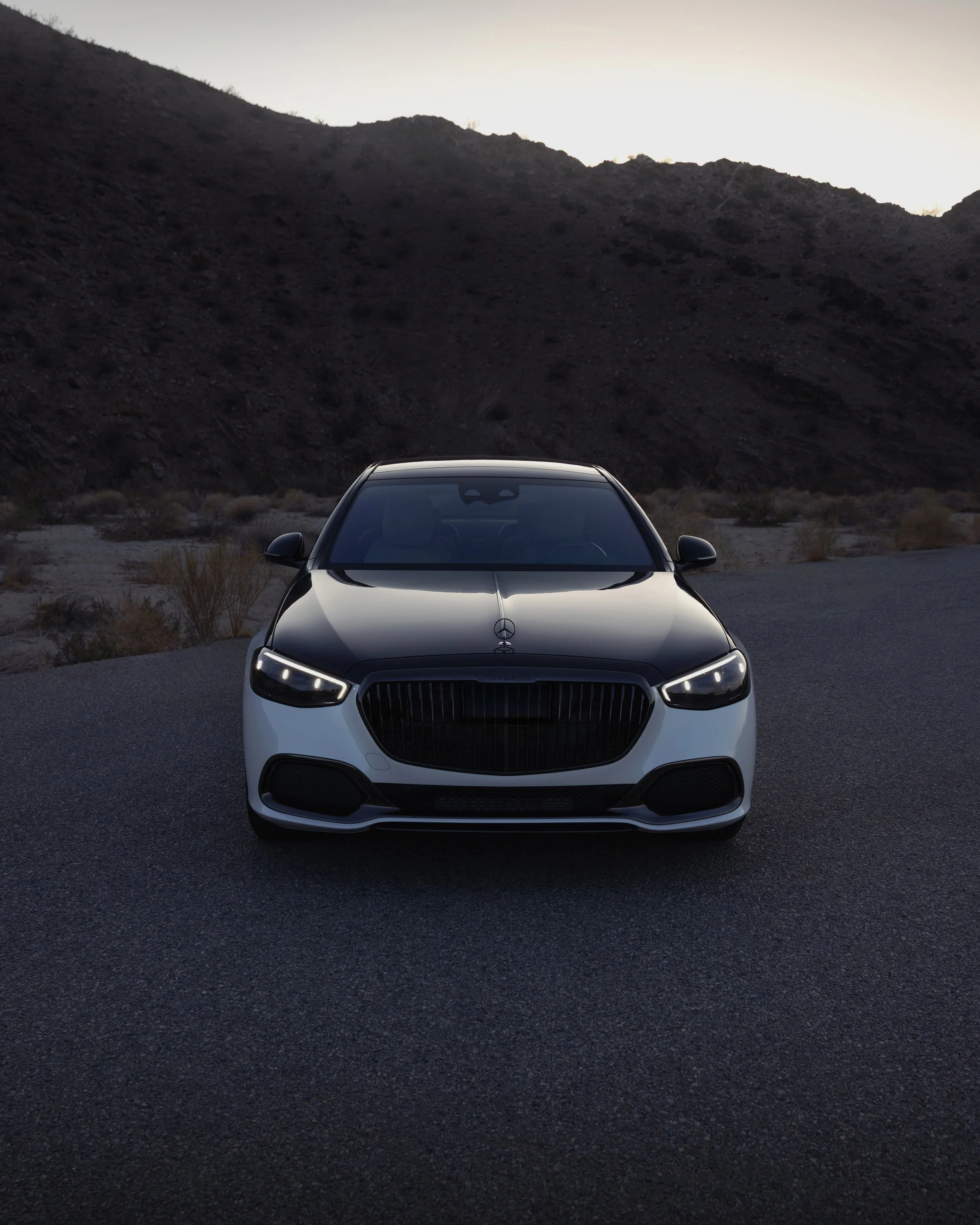 Mercedes-Maybach automotive advertising imagery showcasing the luxury sedan against a dramatic desert landscape