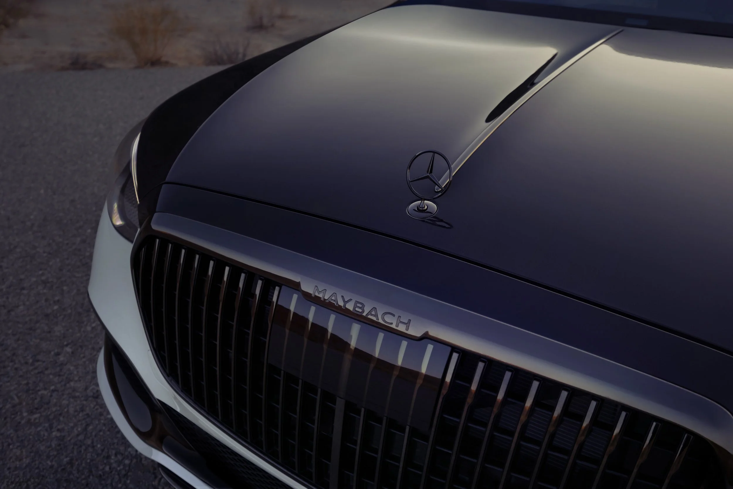 Mercedes-Maybach automotive detail photography highlighting the signature grille, hood ornament, and Nordic Glow two-tone finish