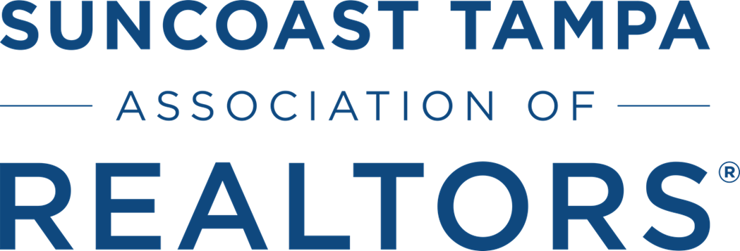 Logo of Suncoast Tampa Association of Realtors with dark blue text on a transparent background.