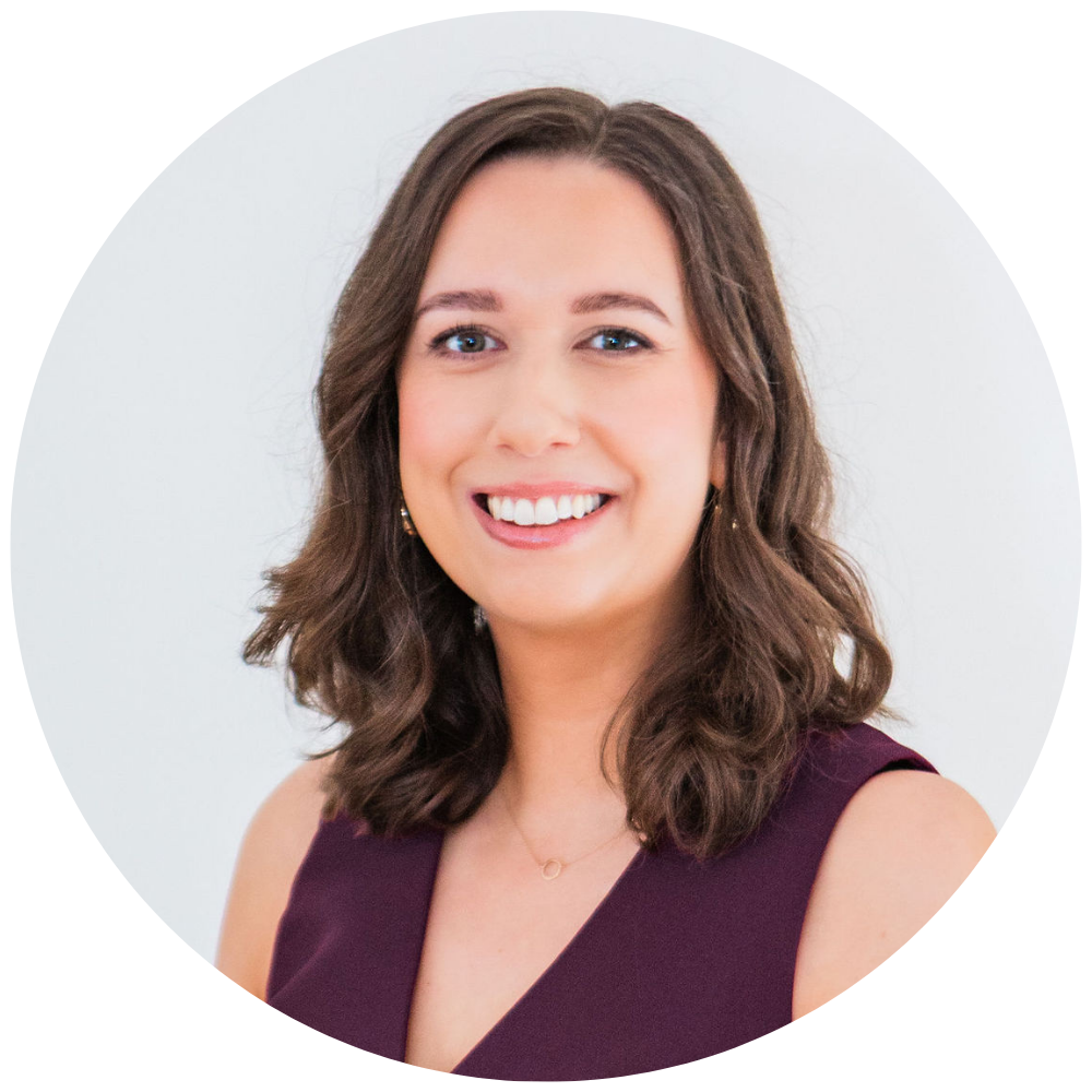 Rachel Grace smiling at the camera, wearing a sleeveless burgundy top and a small necklace against a white background.