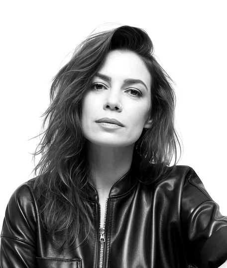 Black and white portrait of a woman with wavy hair, wearing a leather jacket.