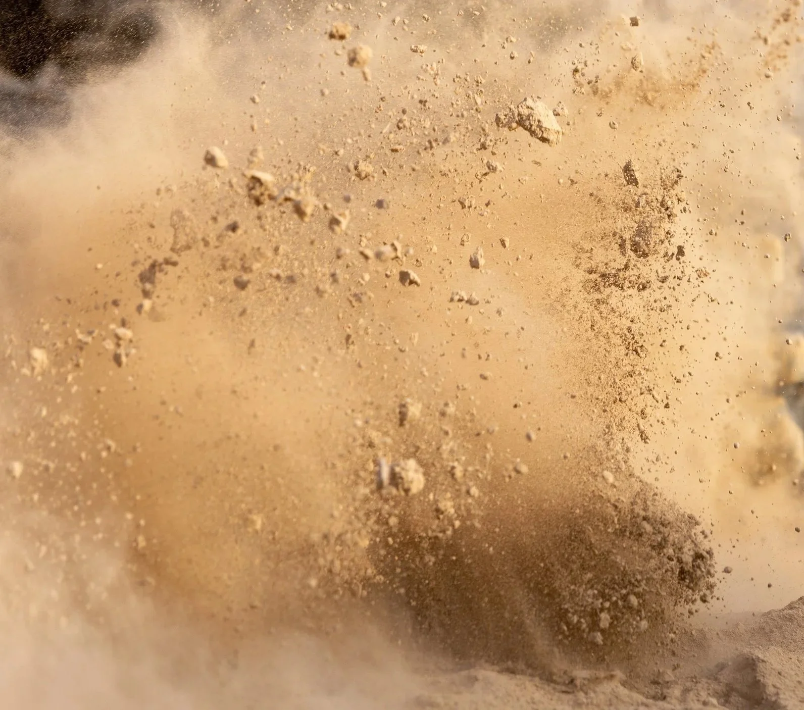 Close-up of dust and small particles creating a cloud of debris.