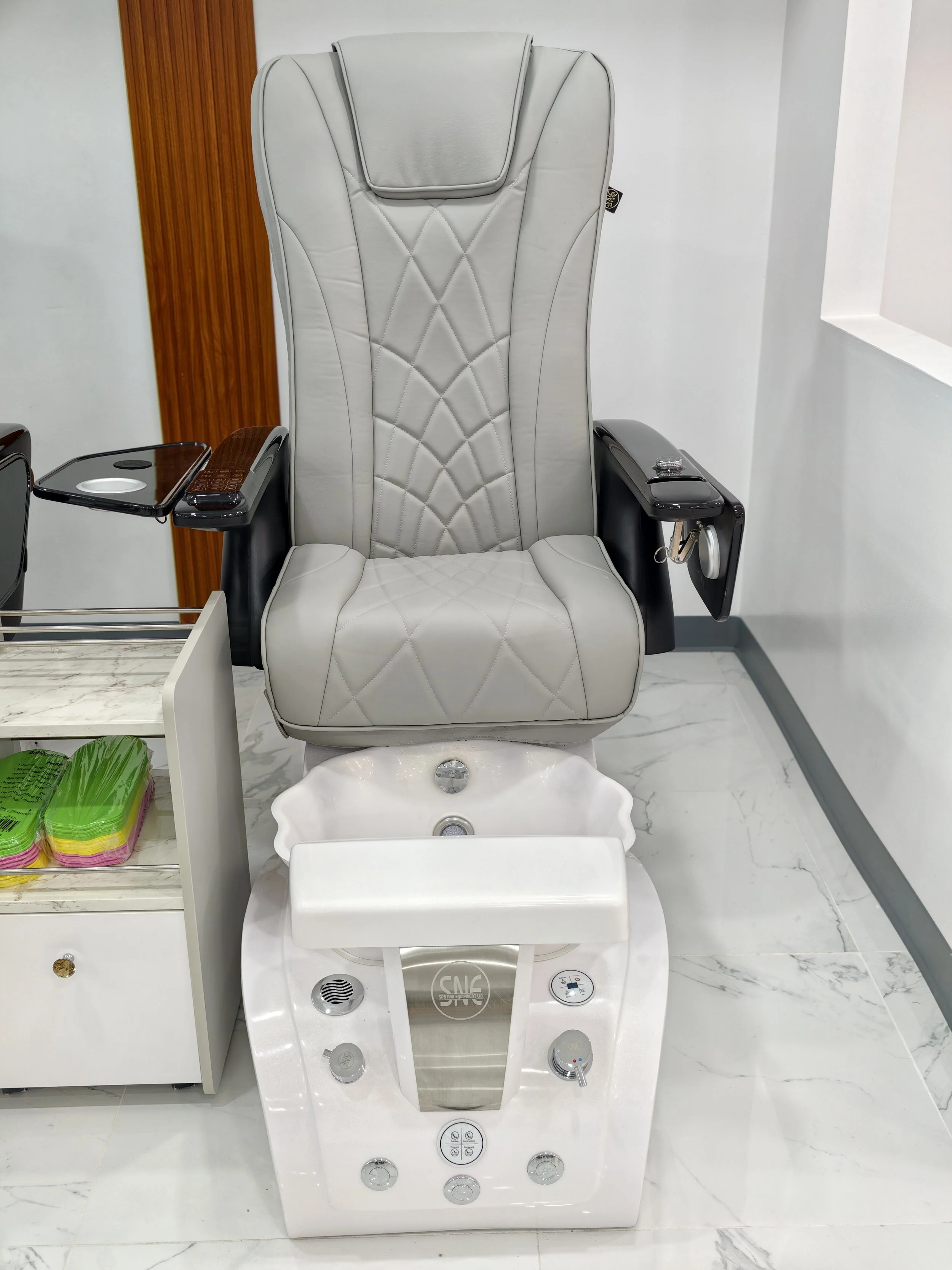 Salon spa chair with a foot massage machine in front of it in a spa or salon setting.