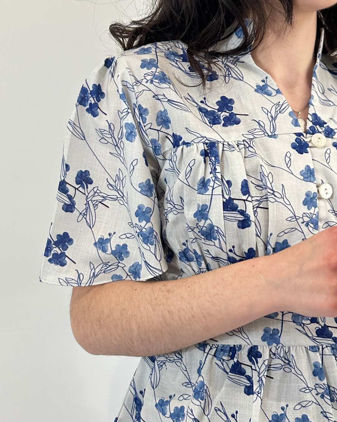 Close-up detail of floral fabric and garment craftsmanship