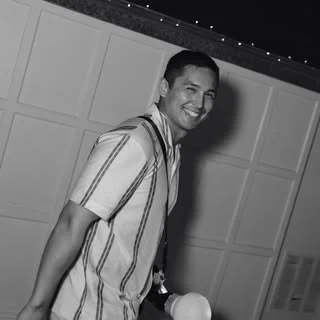 Smiling young man in a striped shirt posing indoors
