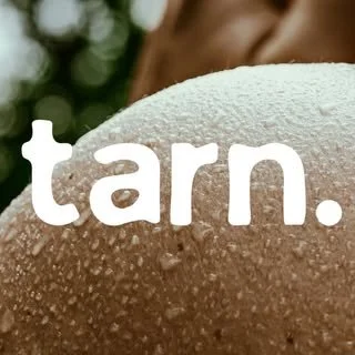 Close-up of a textured surface with the word 'tarn.' written across it in white lowercase letters.