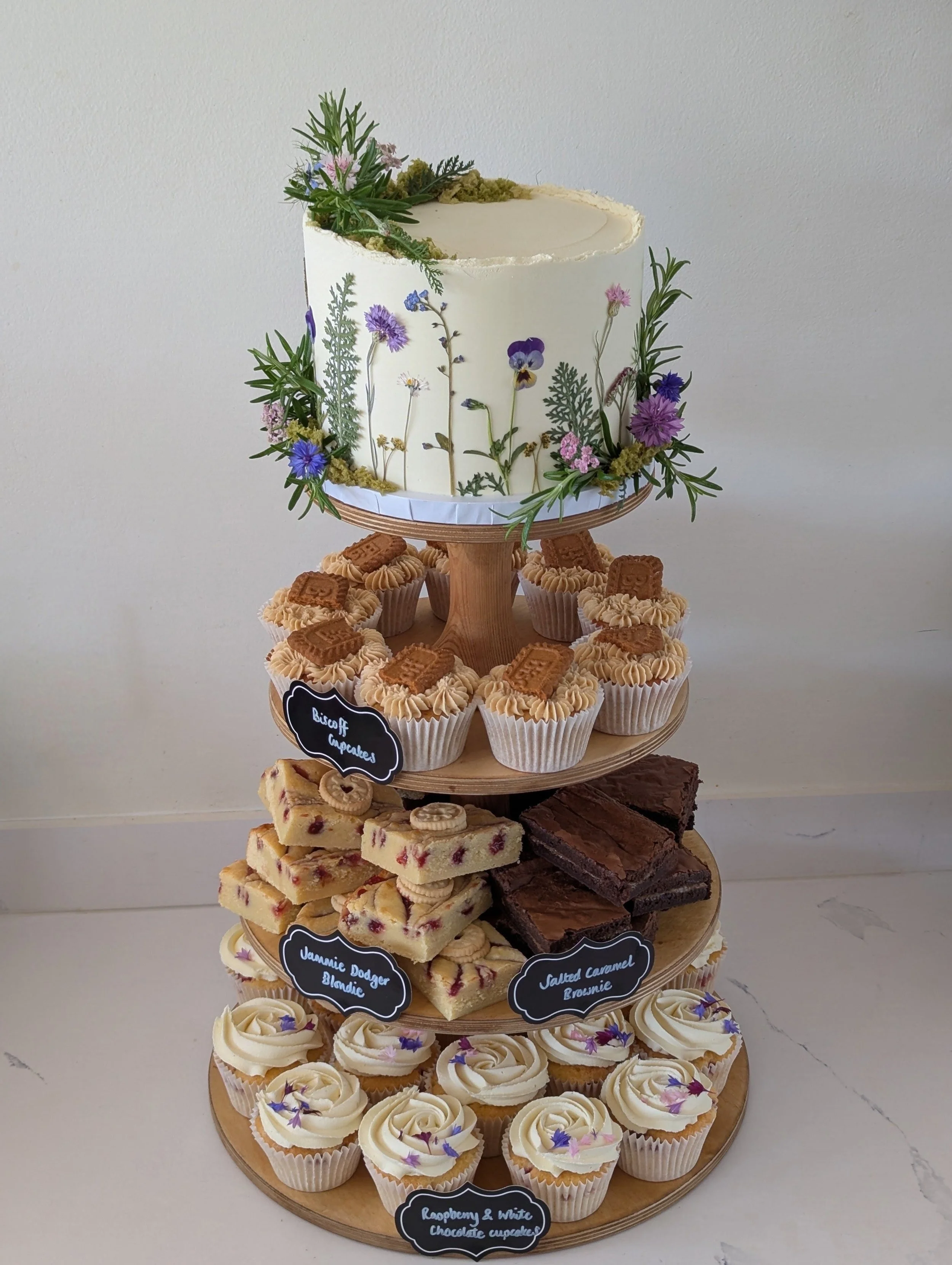 Wedding cake tower with brownies and cupcakes. Pressed edible flowers and foliage for a woodland wedding at the Woods at Oakley.