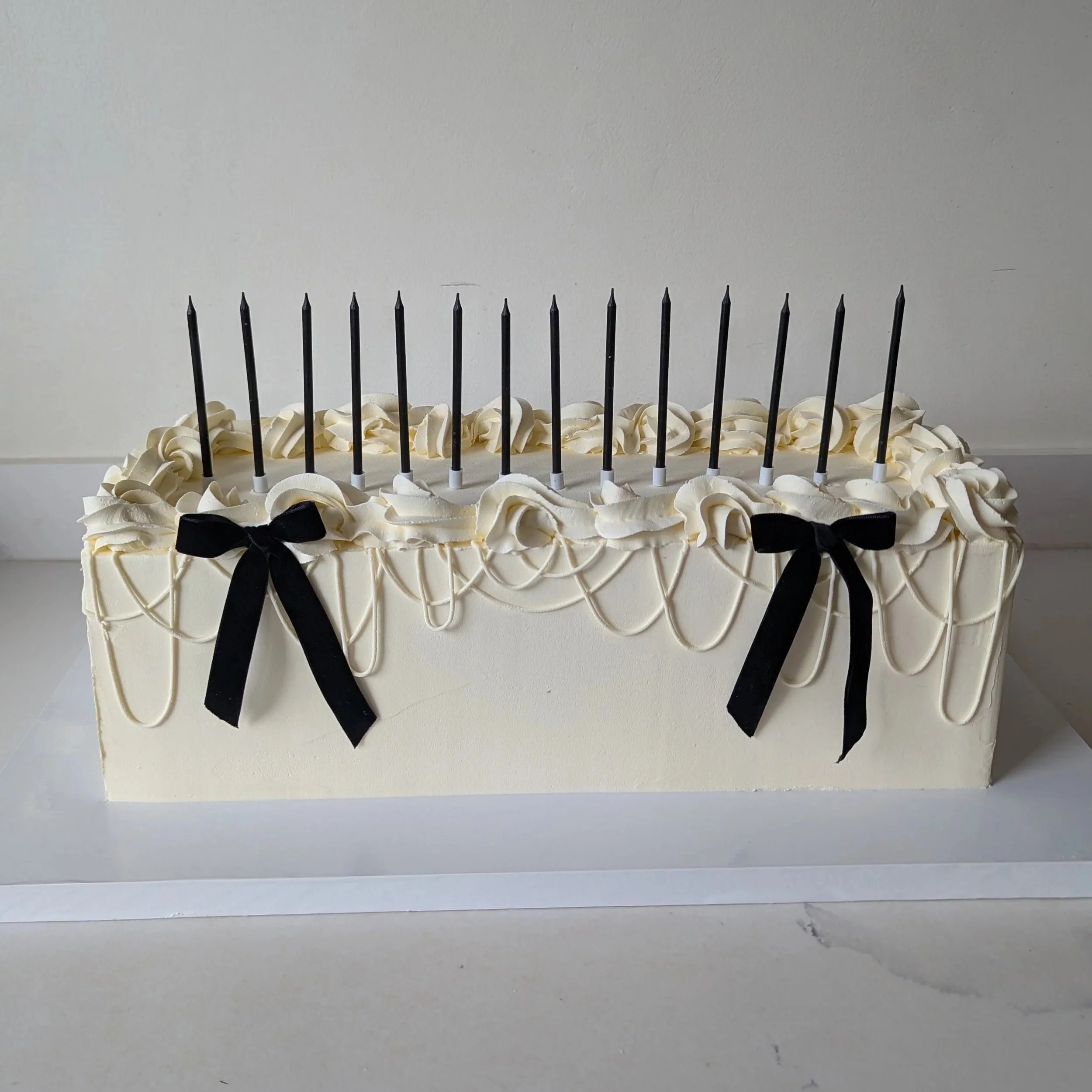 Long rectangle wedding cake with candles in Wiltshire