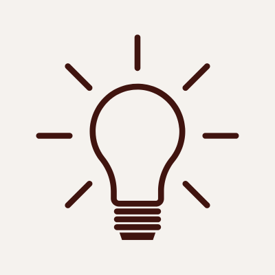 Stylized illustration of a light bulb with rays emanating from it.