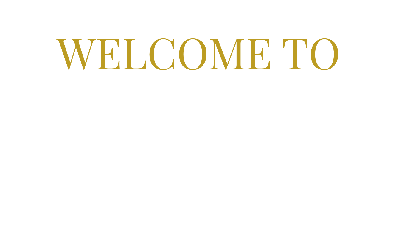 A black sign with gold text that says "Welcome to".